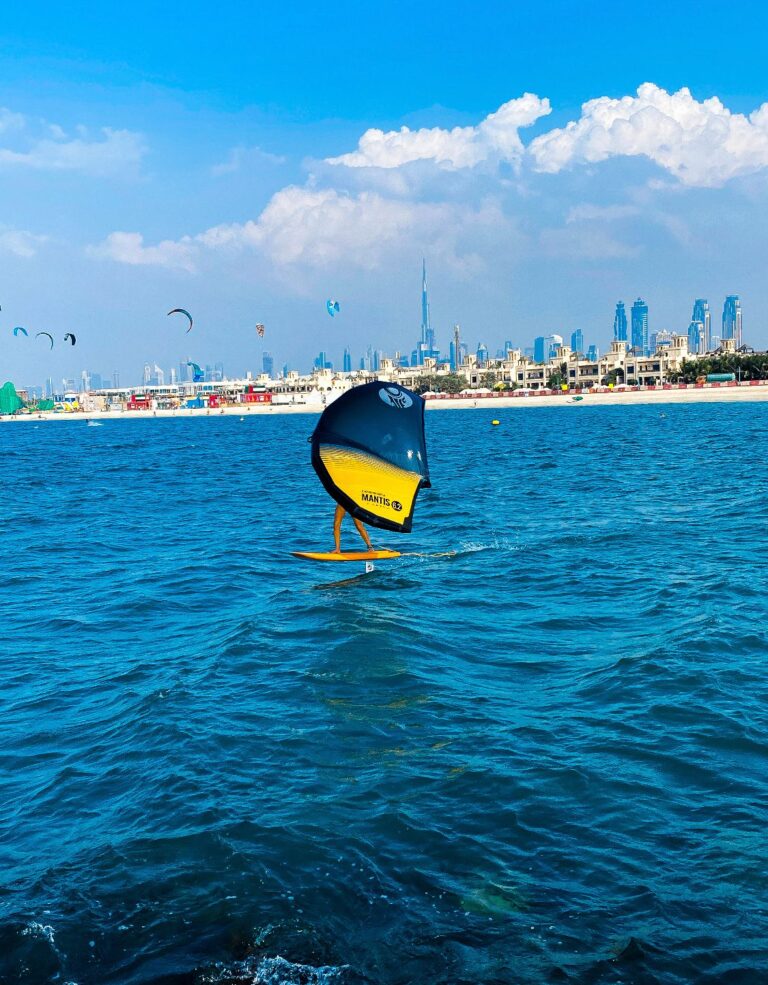 Person paddleboarding on calm waters, enjoying the serene environment, organized by Kite N Surf in Dubai.